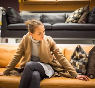 young woman choosing the right furniture for apartment
