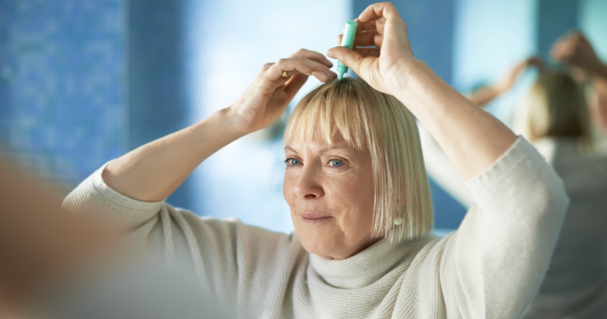 Woman putting on hair glue